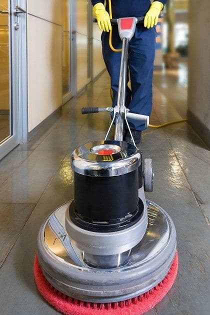 Rotary buffer polishing a tiled corridor floor
